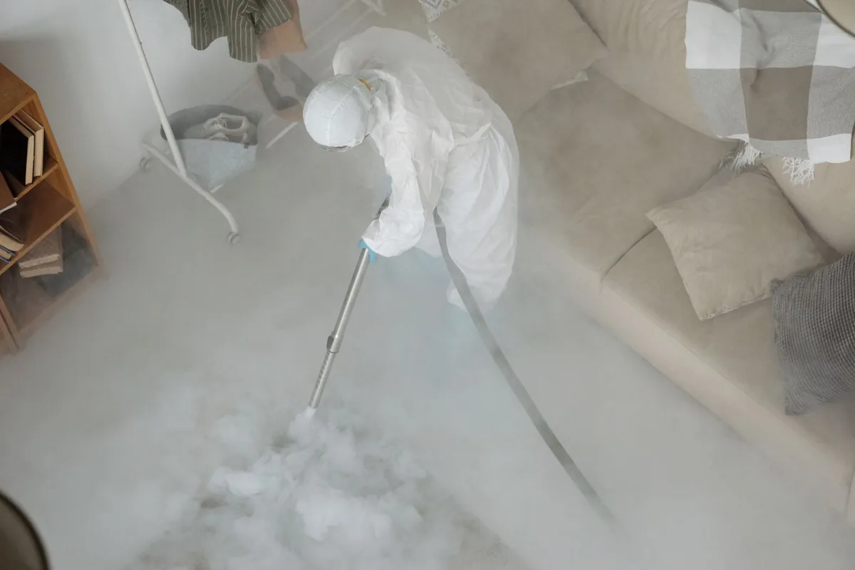 Biohazard cleanup technician in protective equipment, Nazareth College, NY